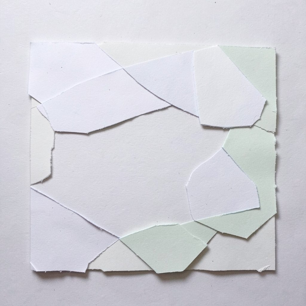 Layered paper-cut collage of a candlelit table setting with dark tablecloth and warm glow
