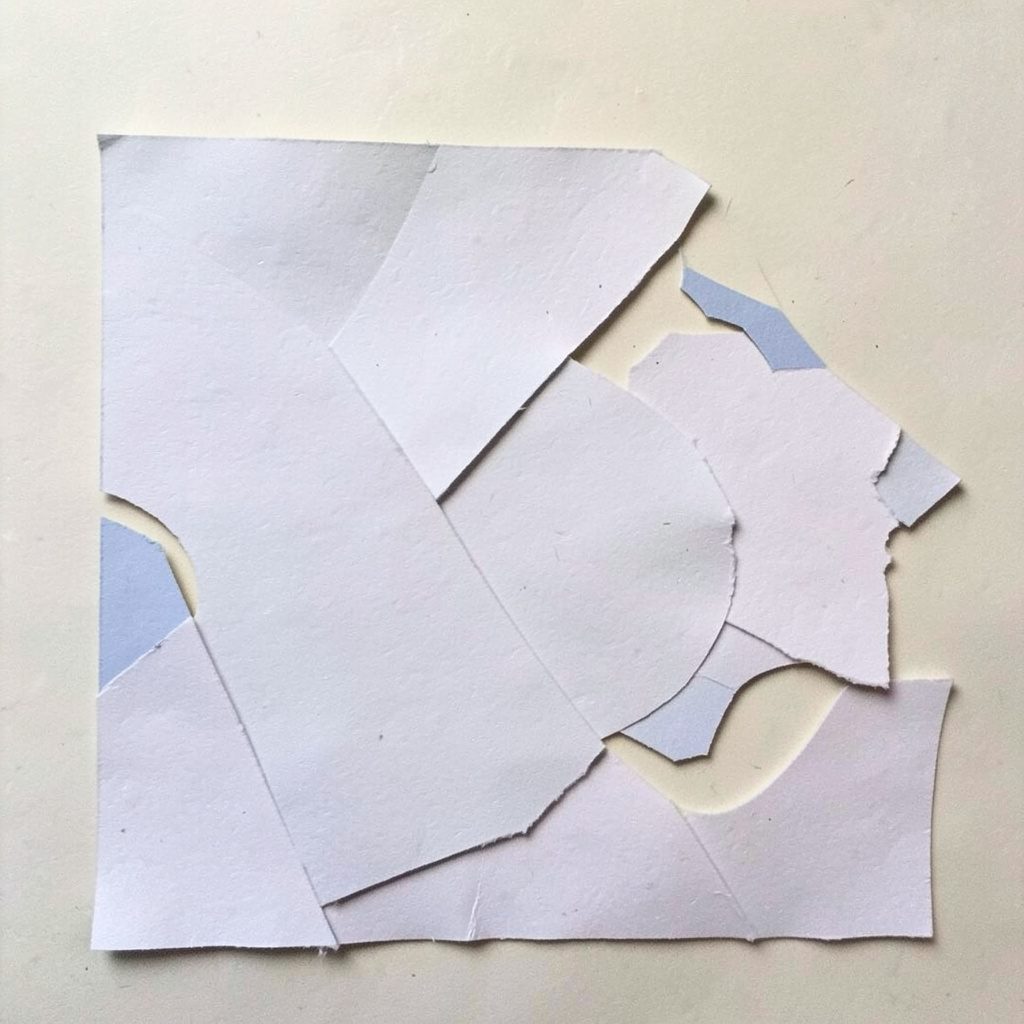 Layered paper-cut collage of a nighttime exterior with glowing signage and warm window light