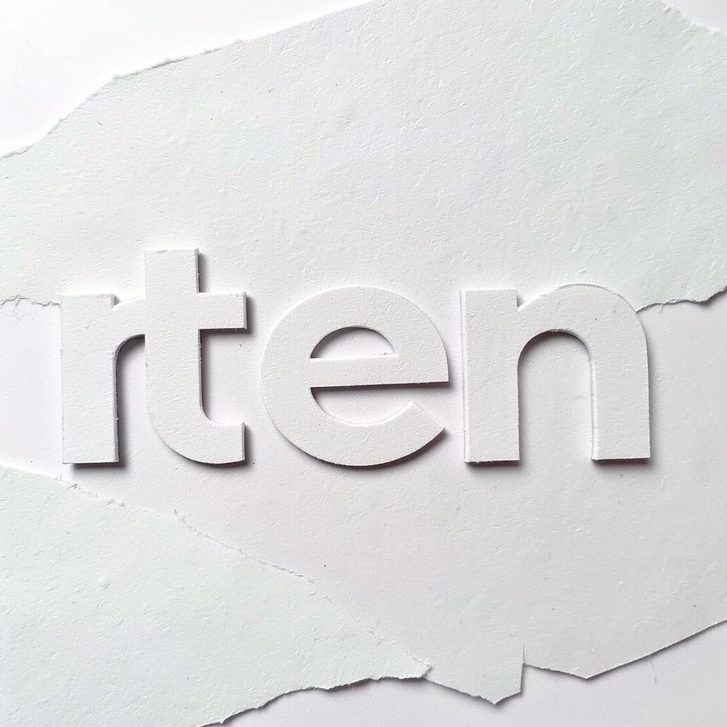 Round 31TEN Lounge emblem with stacked text in warm cream and dark charcoal tones